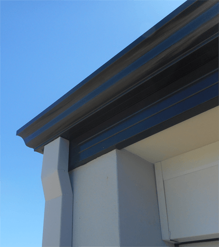 Photo showing downpipe, gutter and fascia on a house