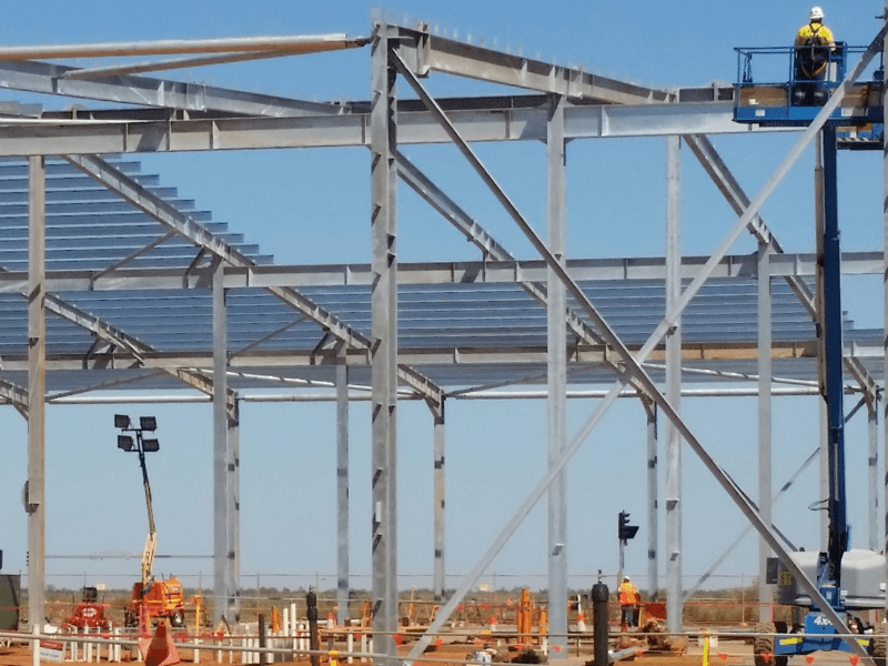 Photo of purlins being installed on a large roof.