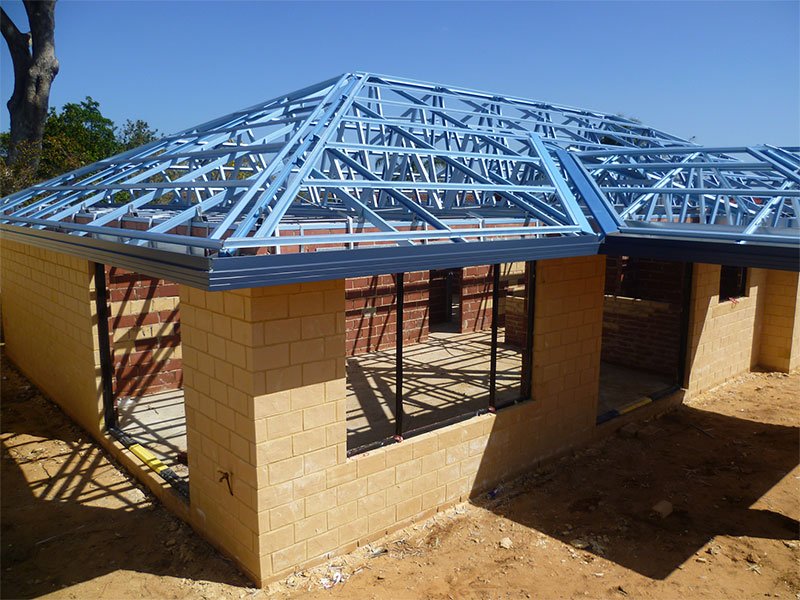 Photo of a house under construction showing steel battens and trusses