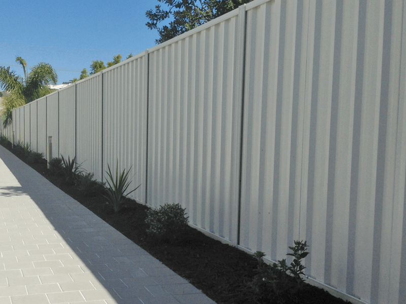 Installed driveway fence made from Trimclad Colourbond fence in Surfmist.